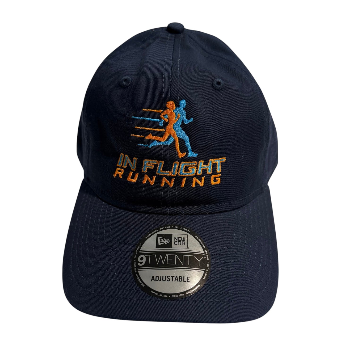 In Flight Running navy blue unstructured cap with embroidered logo and adjustable strap. Cotton material.