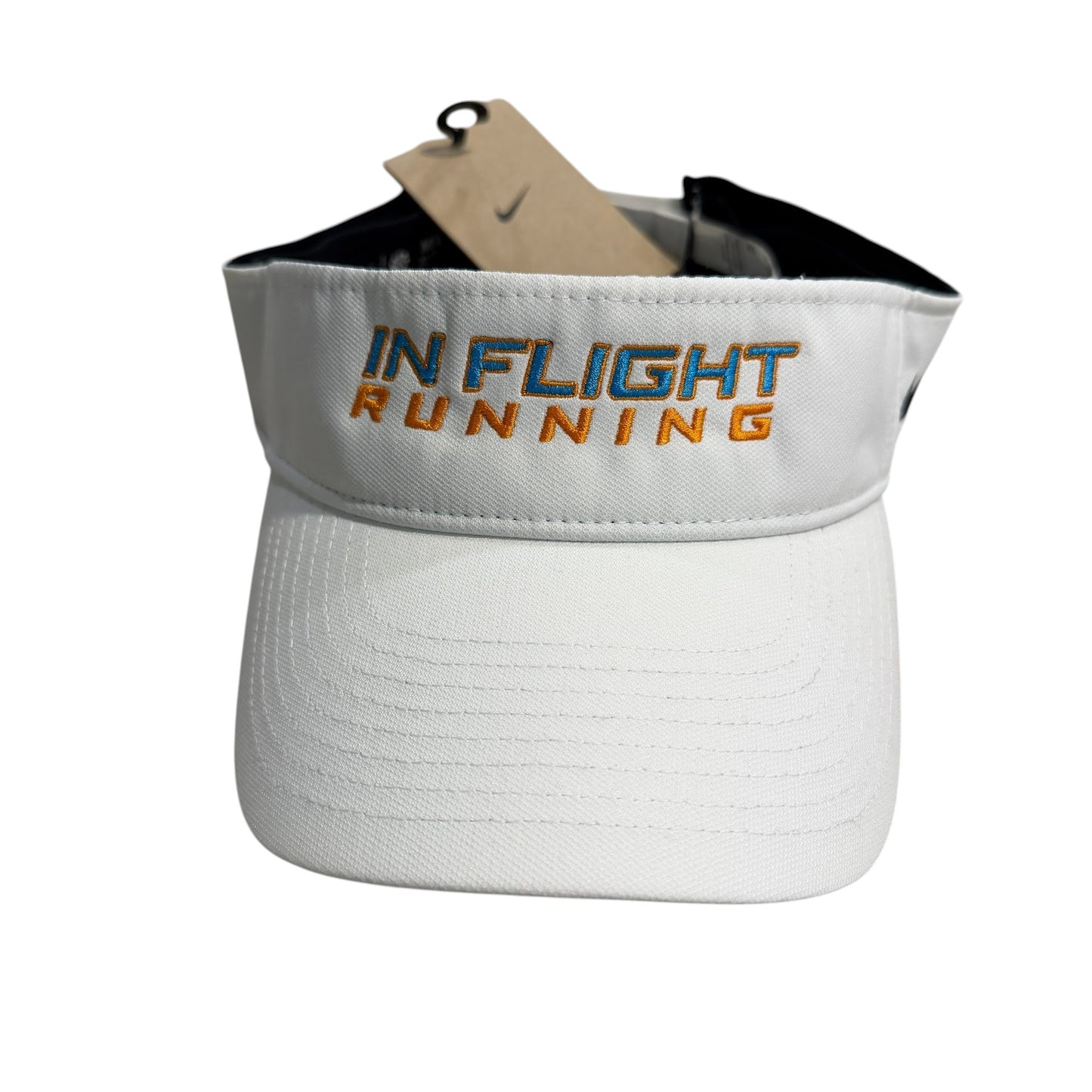 White Nike Dry-Fit performance running visor with "IN FLIGHT RUNNING" embroidered in blue and orange. Features a pre-curved bill and hook and loop closure.